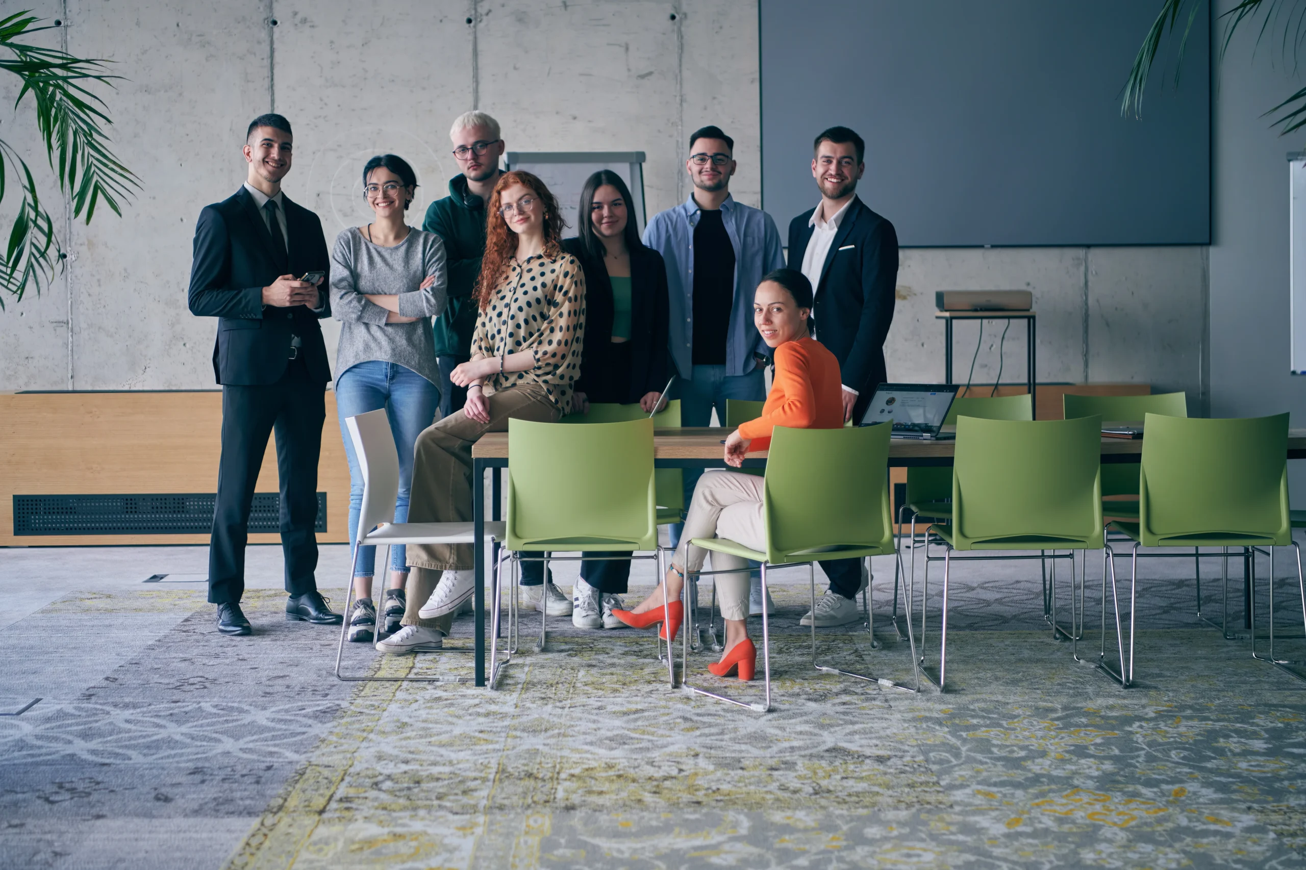 NACFB, A diverse group of successful businesspeople gather and pose for a photo, showcasing teamwork and professional empowerment in a modern office setting.
